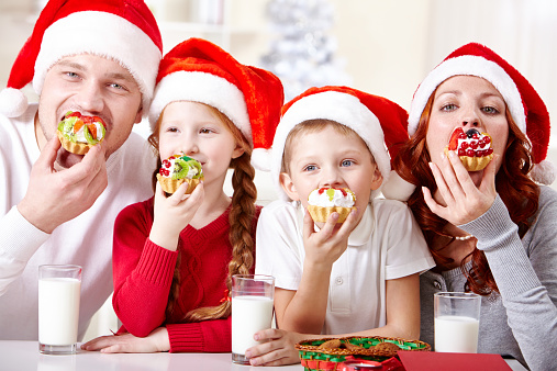 family eating Christmas tasty cupcakes