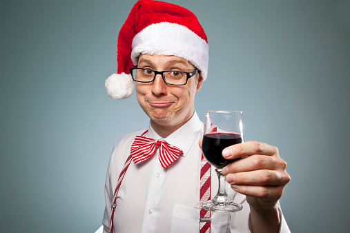 A nerd dressed up in a Christmas outfit offering you a drink- merry Christmas! Cheers!