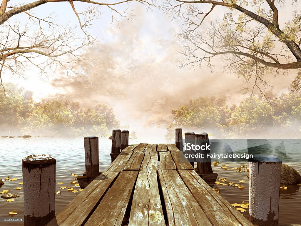 Wooden dock with tree branches Wooden dock on a lake with leaves and tree branches Autumn Stock Photo