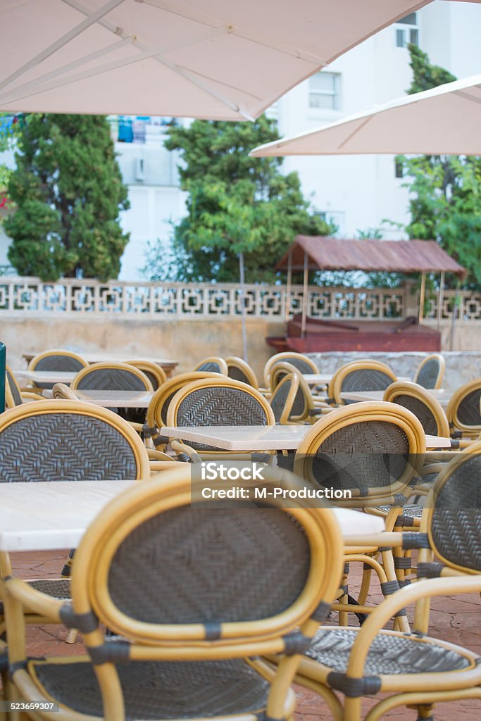 Empty outdoor street cafe. Chairs with tables. Arranging Stock Photo