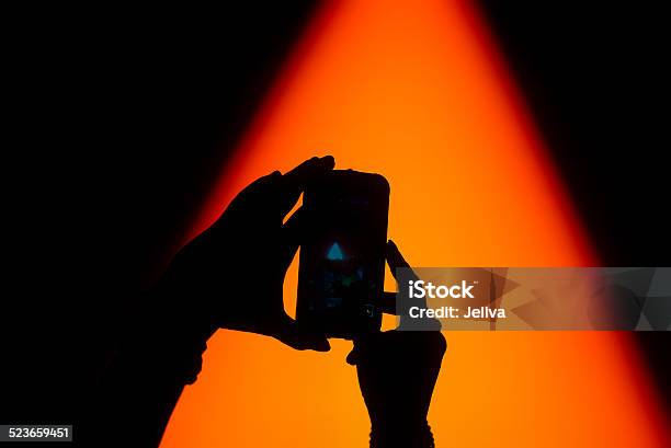 Silhouette Of Hands Taking A Photo On Concert Stock Photo - Download Image Now - Arts Culture and Entertainment, Audience, Camera - Photographic Equipment