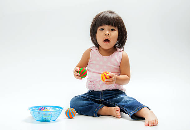 istock asian girl play colour ball 523660343