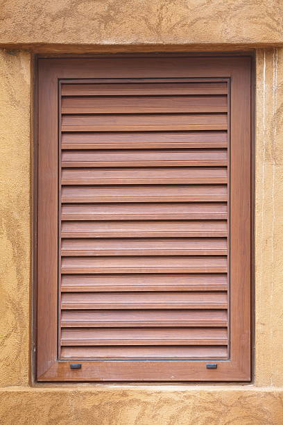 istock Wooden window on brown cement design wall 523661899