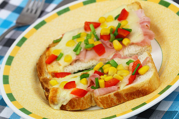 istock Toast with mozzarella, ham, red pepper and sweetcorn 523661909