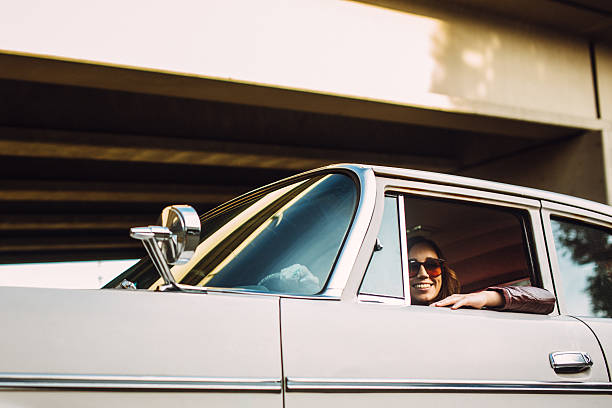 istock Happy Woman in Classic Car 523663225
