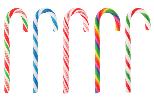 Candy canes piled on a frosted surface. Christmas holiday theme, shallow depth of field.