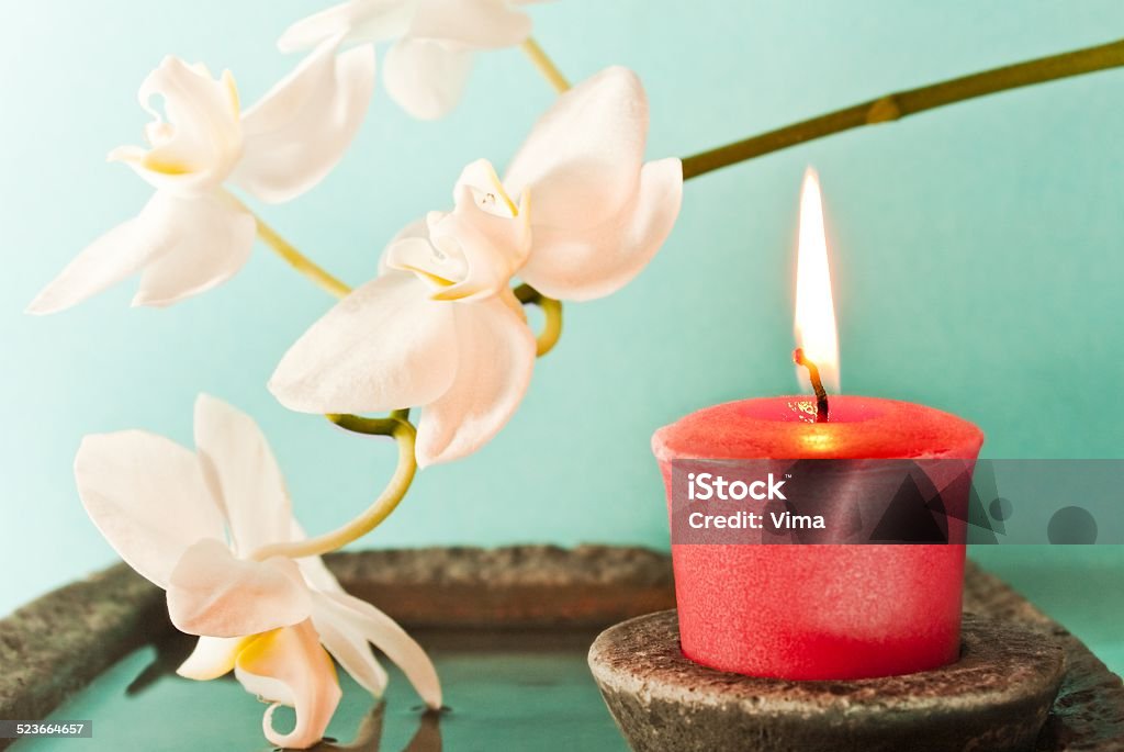 Recreation red candle and white orchid flower Ayurveda Stock Photo