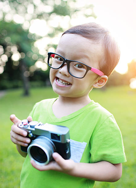 istock cute child plays the photographer 523665285