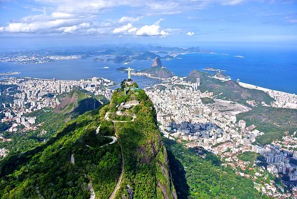 The Christ Redeemer overlooking Rio de Janeiro Aerial view of the Christ Redeemer overlooking Rio de Janeiro, with the SugarLoaf rio de janeiro stock pictures, royalty-free photos & images
