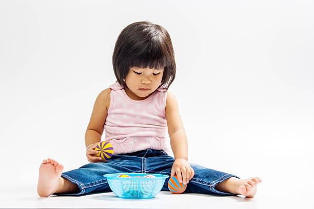 istock asian girl play colour ball 523673675