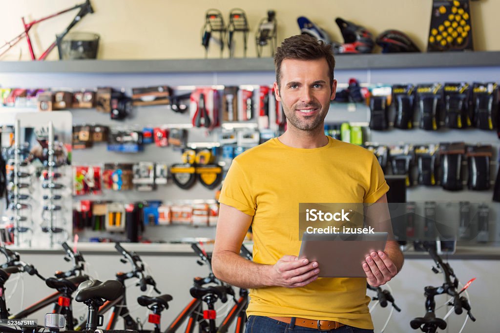 Sport store manager with digital tablet Portrait of manager of sports store, standing with digital tablet and smiling at camera. Store Stock Photo