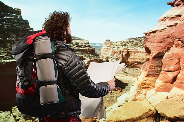 istock Rear view of  hiker holding map 523675521