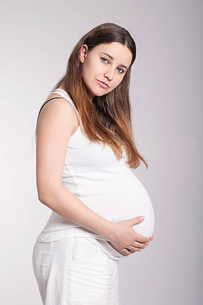 istock Pregnant woman holding her belly 523676255