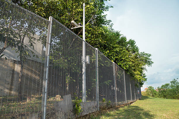 istock Security boundary fencing at residential community 523678739
