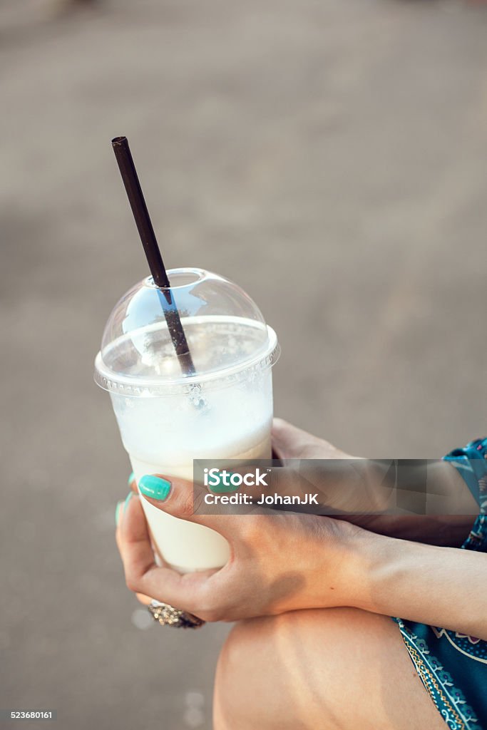 Woman with glasses drinking milkshake Girl with glasses drinking milkshake. Outdoor lifestyle portrait of woman Adult Stock Photo