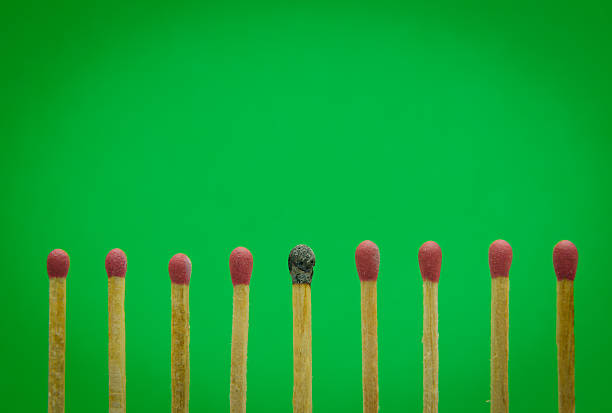 istock burned match setting on green background for ideas and inspiration 523680883