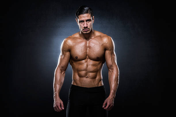 Portrait of male shirtless athlete Lifestyle portrait of attractive shirtless male bodybuilder with well toned muscles. pectoral muscle stock pictures, royalty-free photos & images