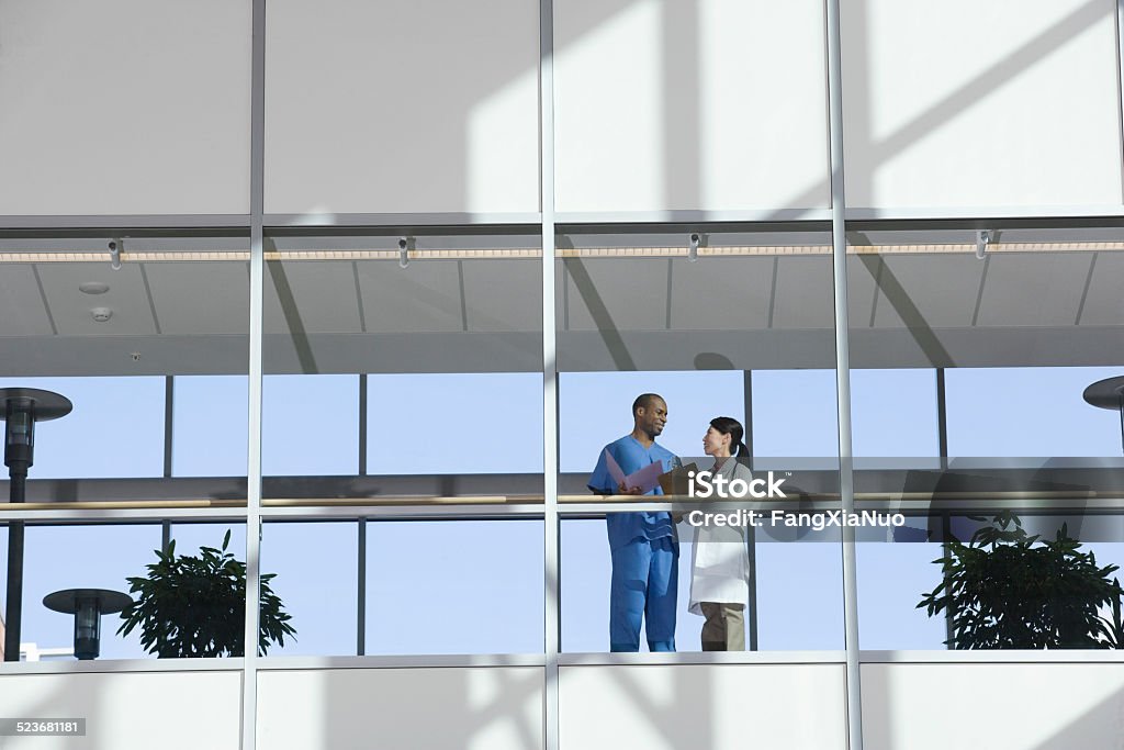 Two Doctors Talking in Corridor Hospital Stock Photo