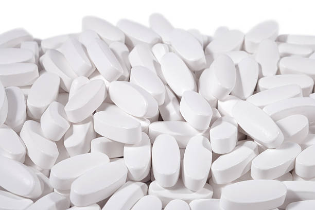 istock Heap of white pills 523681305
