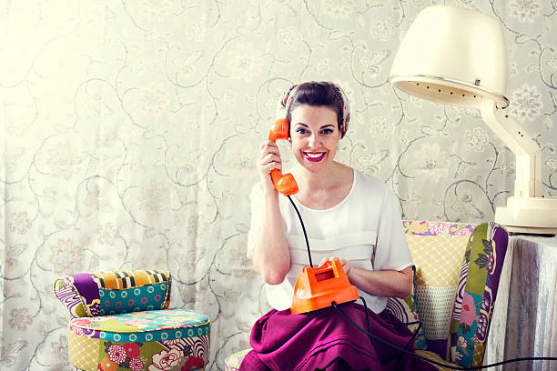 vintage housewife chats on the phone in Hair salon stock photo