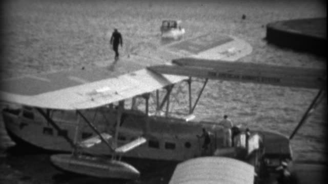 1935: Important people exiting Pan Am Sikorsky S-40 sesquiplane amphibious flying boat.