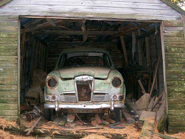 istock Rusty Old Green Vintage Car In Dilapidated Shack 523689146