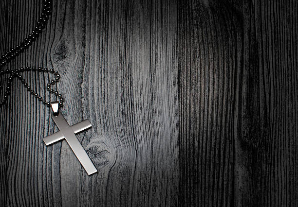 istock Metal cross on a wooden background 523689366
