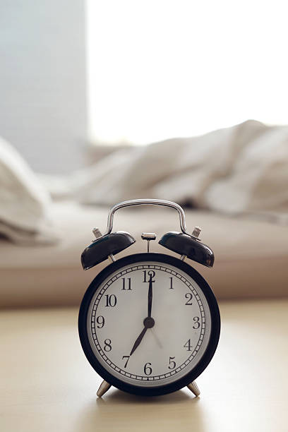 istock alarm clock on the night table in the bedroom 523689898