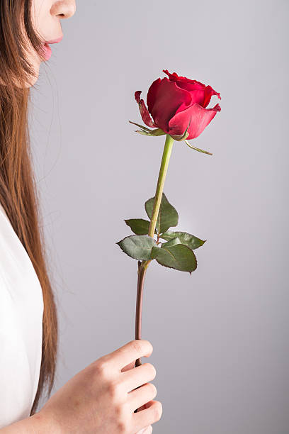 istock young asian girl holding rose 523690542