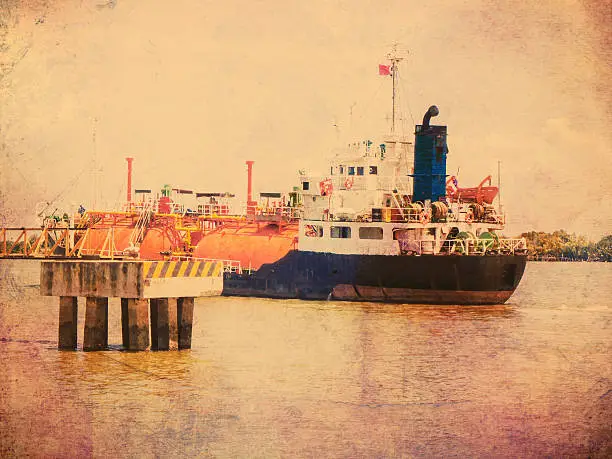 gas-carrier ship in port with vintage grunge filter effect background