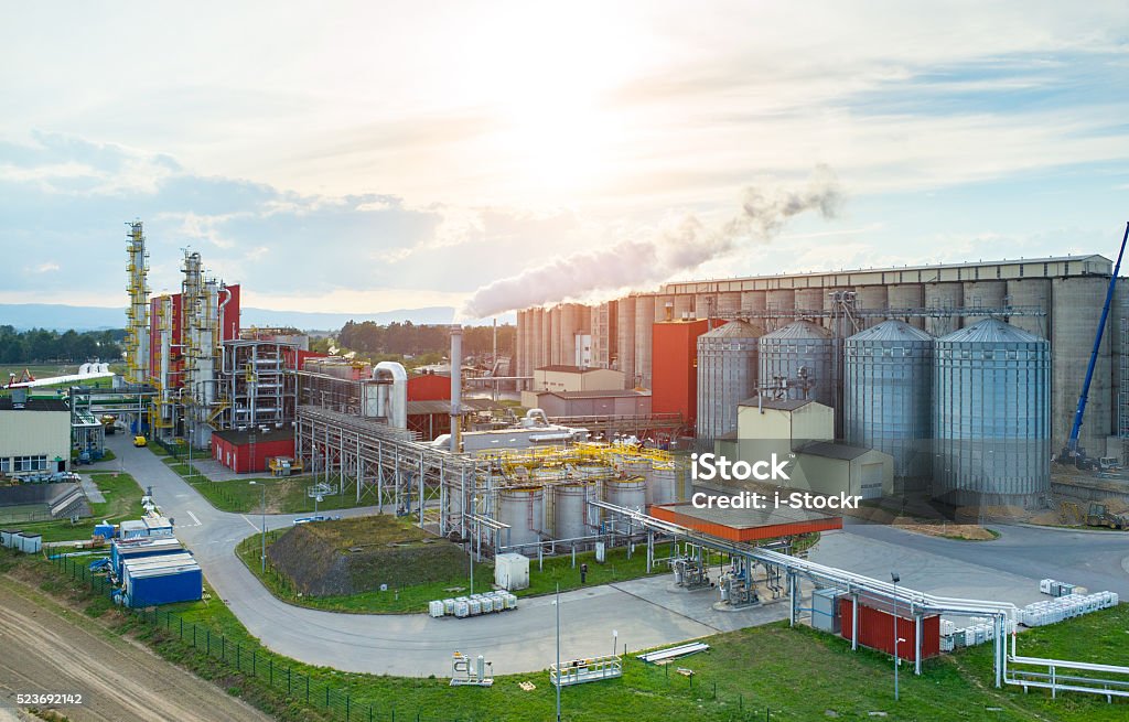 Sunset over biofuel factory Beautiful sunset over the modern biofuel factory Factory Stock Photo