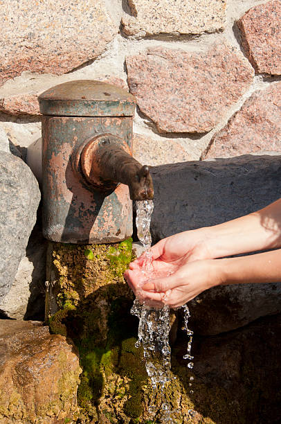 istock female hands under the column  of water 523692193