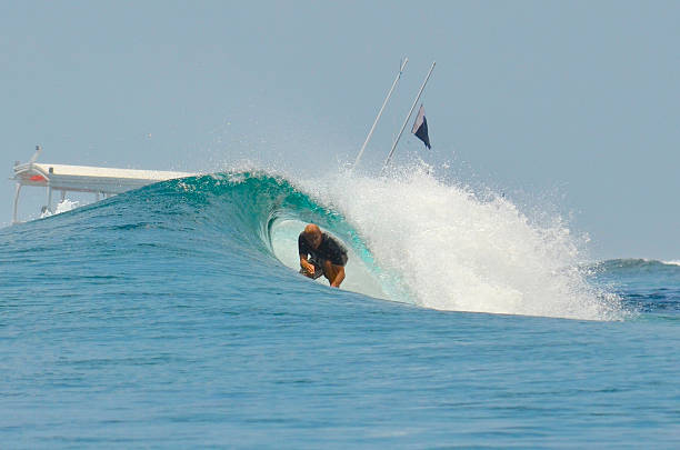 Surfer among the foliage of El Tunco beach, Sunzal, El Salvador