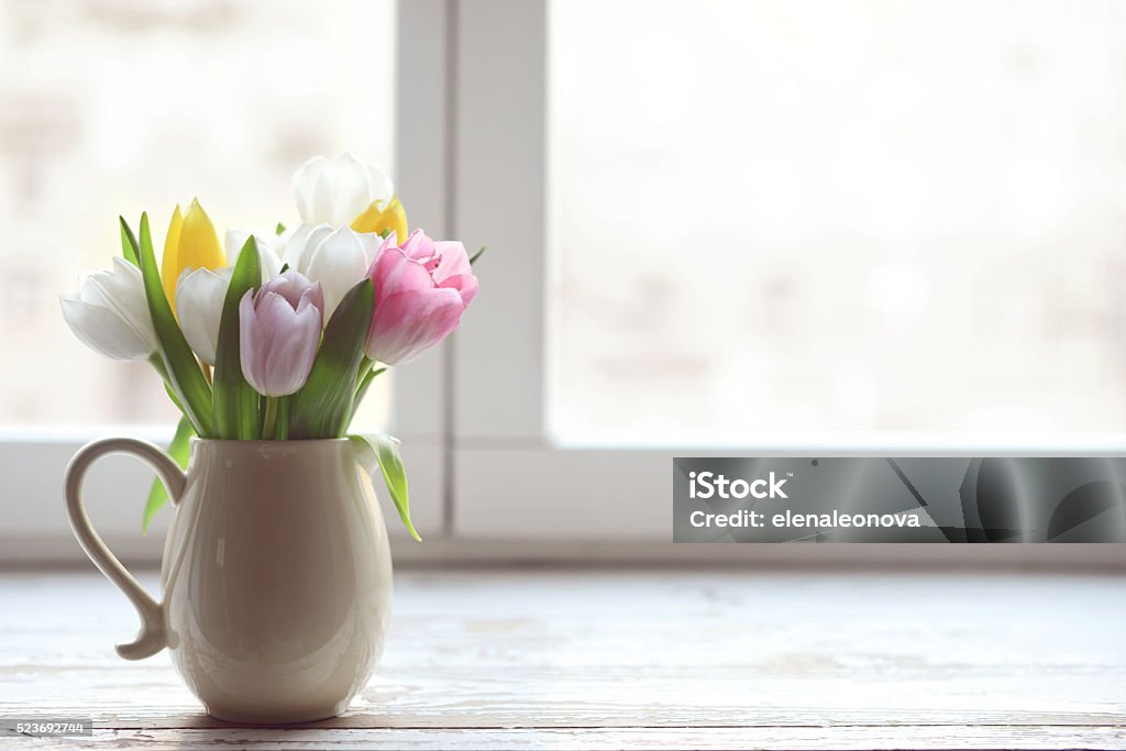 bouquet of tulips bouquet of tulips in a vase on a window sill at the window Flower Stock Photo