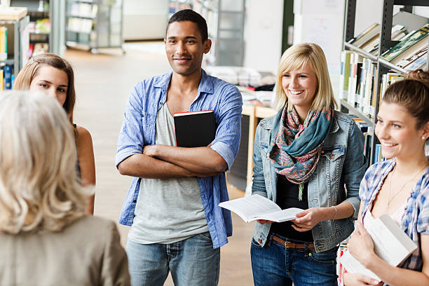 istock Students Listening To Teacher In Library 523693721
