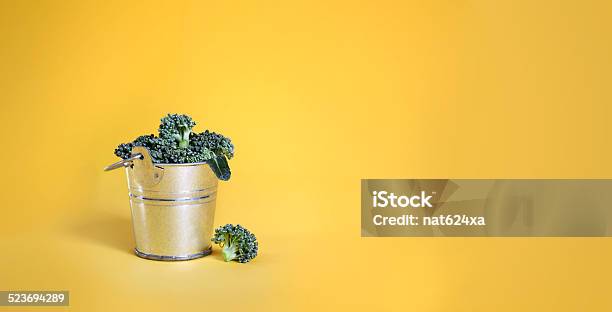 Broccoli In A Bucket On Yellow Background Stock Photo - Download Image Now - Agriculture, Autumn Salad, Broccoli