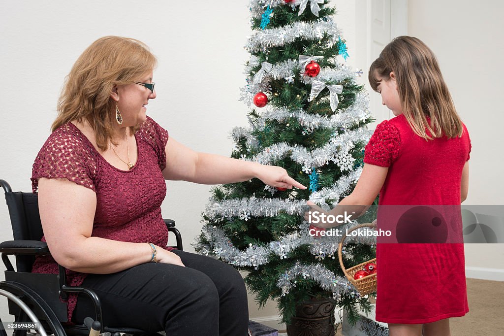 Tochter mit Mutter dekorieren Weihnachtsbaum im Rollstuhl - Lizenzfrei Andersfähigkeiten Stock-Foto