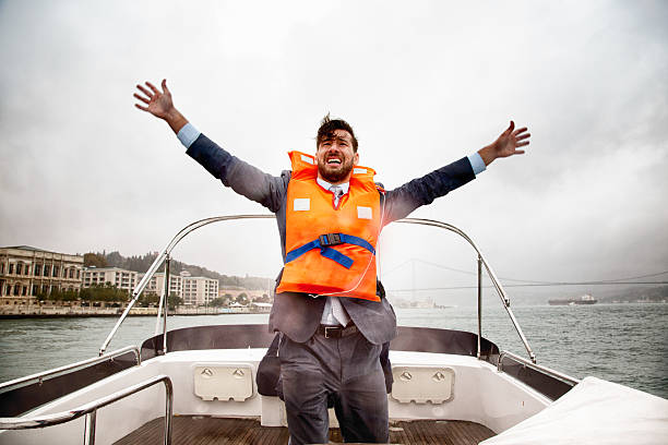 istock Anxious businessman waves for help on sinking ship 523695813
