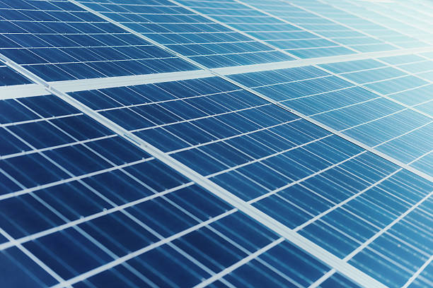 istock solar panels against a sunny sky with sun flares 523696319