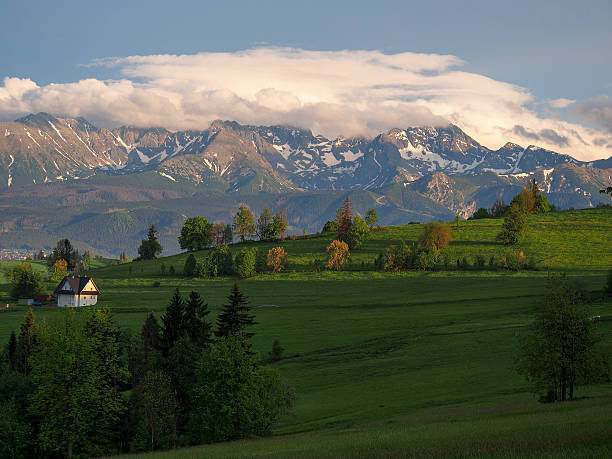 istock Summer sunrise mountain village outskirts view and Tatra range b 523696515