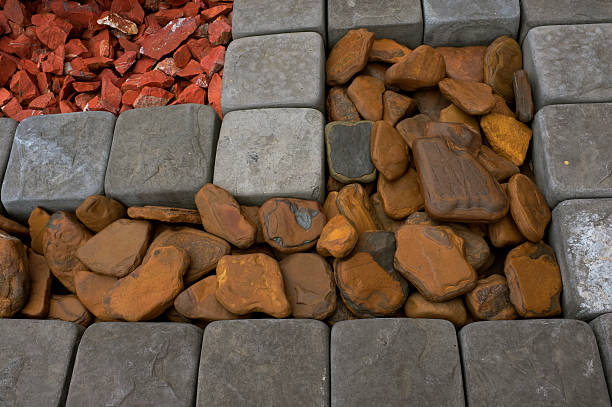 This is an image showing some options of colourful rock aggregates and square cobble pavers that can be used in garden design.