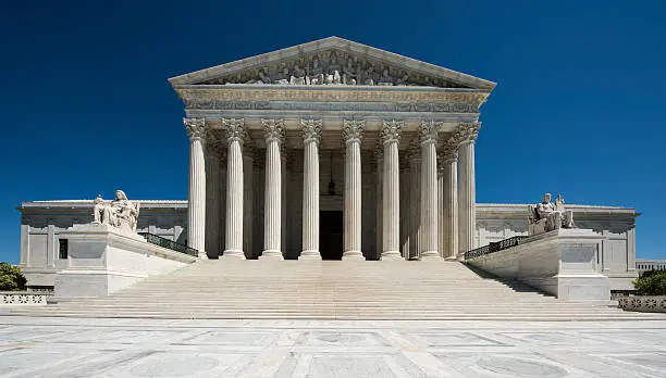 United States Supreme Court full frontal view, brilliant blue sky, No People