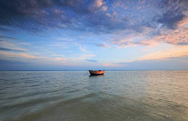 istock Lonely boat sea at dusk 523698919