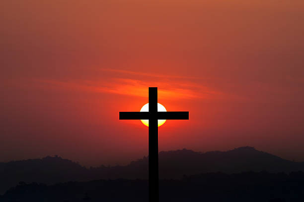 istock Silhouette of cross over sunset background 523699400