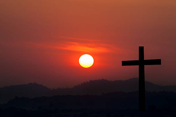 istock Silhouette of cross over sunset background 523699430