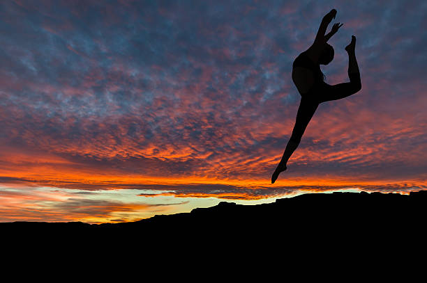 istock Silhouette of Woman Dancing Outdoors at Sunset 523699732