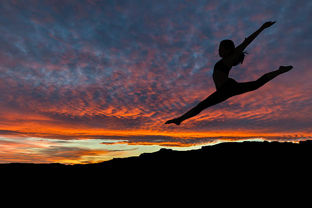 istock Silhouette of Woman Dancing Outdoors at Sunset 523699744