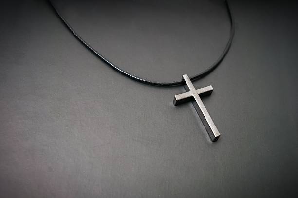 istock Necklace with metallic cross on dark background. 523700912