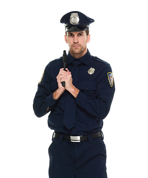 istock Police holding gun and looking at camera 523702246