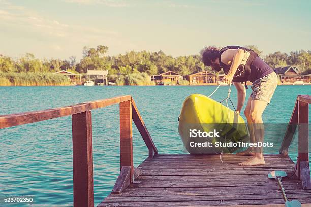 The Man Putting Kayak Into The Water Stock Photo - Download Image Now - 30-39 Years, Active Lifestyle, Activity